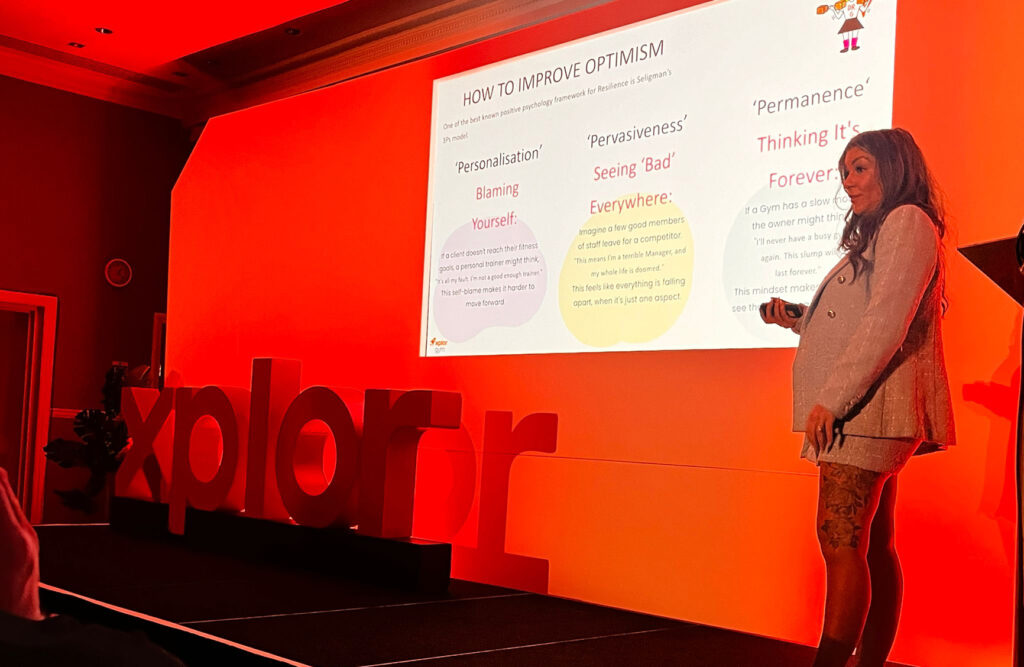 A photo of Lara Hall-Bryce from Resilient as Fudge, on stage at the Xplor Xperience in May 2024 at The Park Royal Hotel in Cheshire, UK.