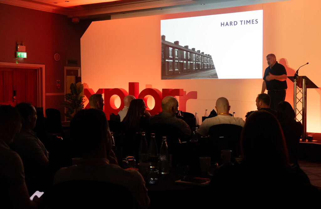 A photo of Shaun Wane, Rugby League Coach, on stage at the Xplor Xperience in May 2024 at The Park Royal Hotel in Cheshire, UK.